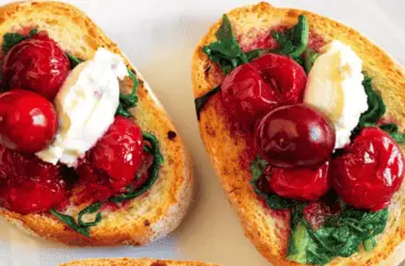 Bruschetta with cherries, wilted bitter greens and ginger compote