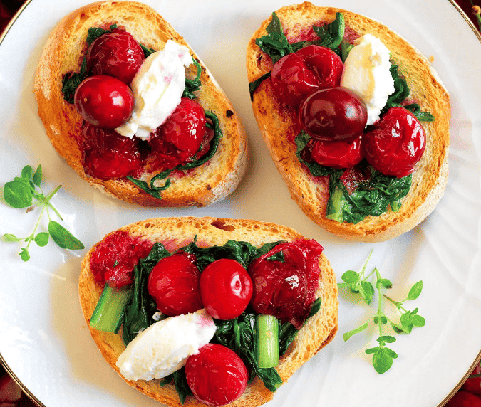Bruschetta with cherries, wilted bitter greens and ginger compote